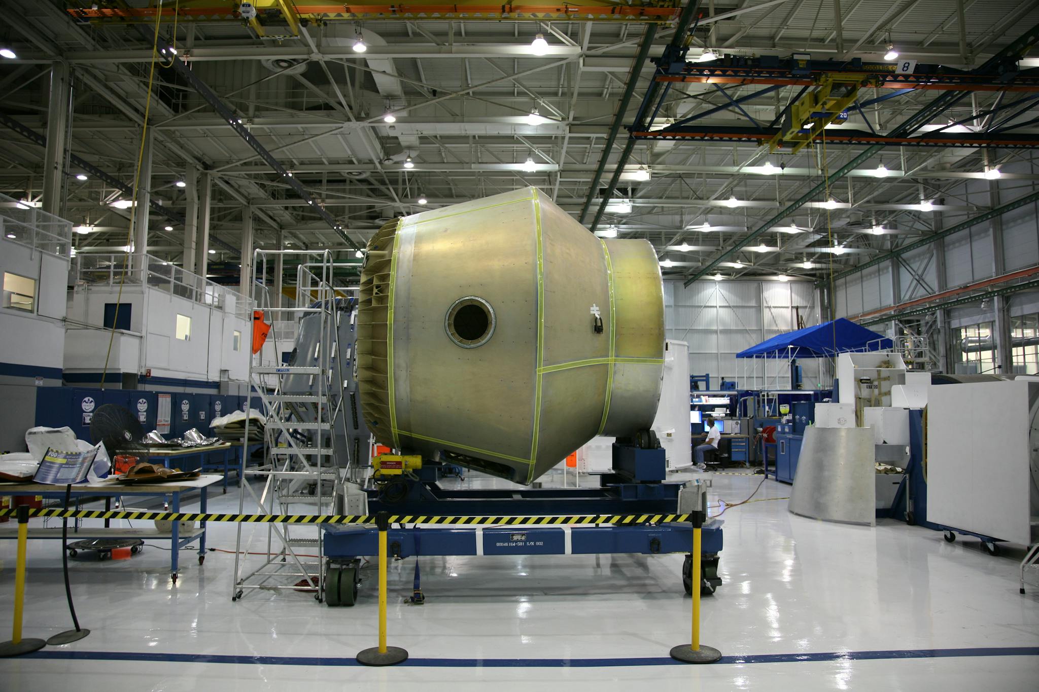 Heavy detail of spacecraft placed on rolling platform under construction at futuristic rocket factory
